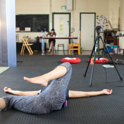 Movement Alphabet by Jan Lee and Tim Murray-Browne, interactive participatory installation mapping body movement into generative visuals. Jan lying on floor with Kinect in background during artistic residency at GAS Station, East London